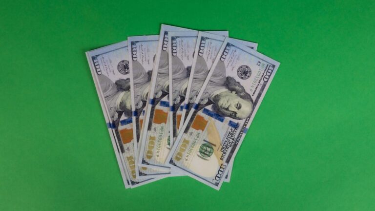 100 dollar bills on a green background