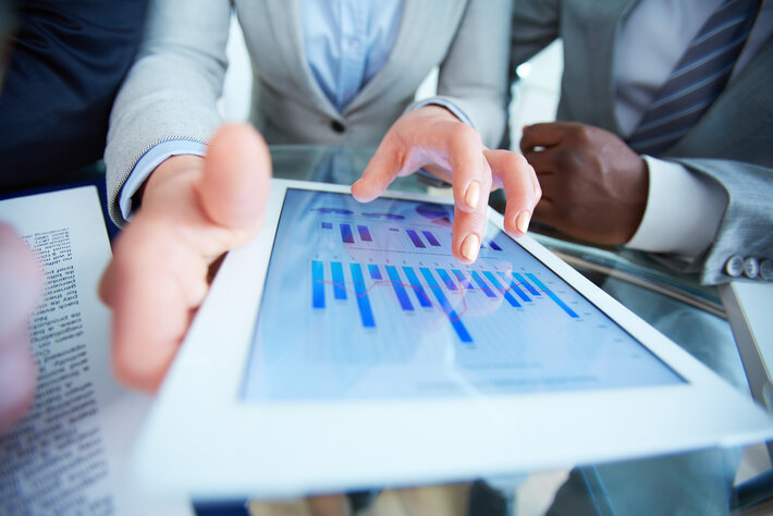 Human hands during discussion of business document in touchscreen at meeting